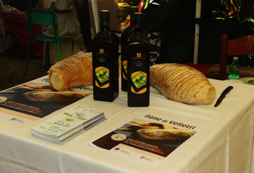 Olio extra vergine di oliva e pane tradizionale tipici di Velletri su tavola rustica a Velletri 'Pane e Olio'.